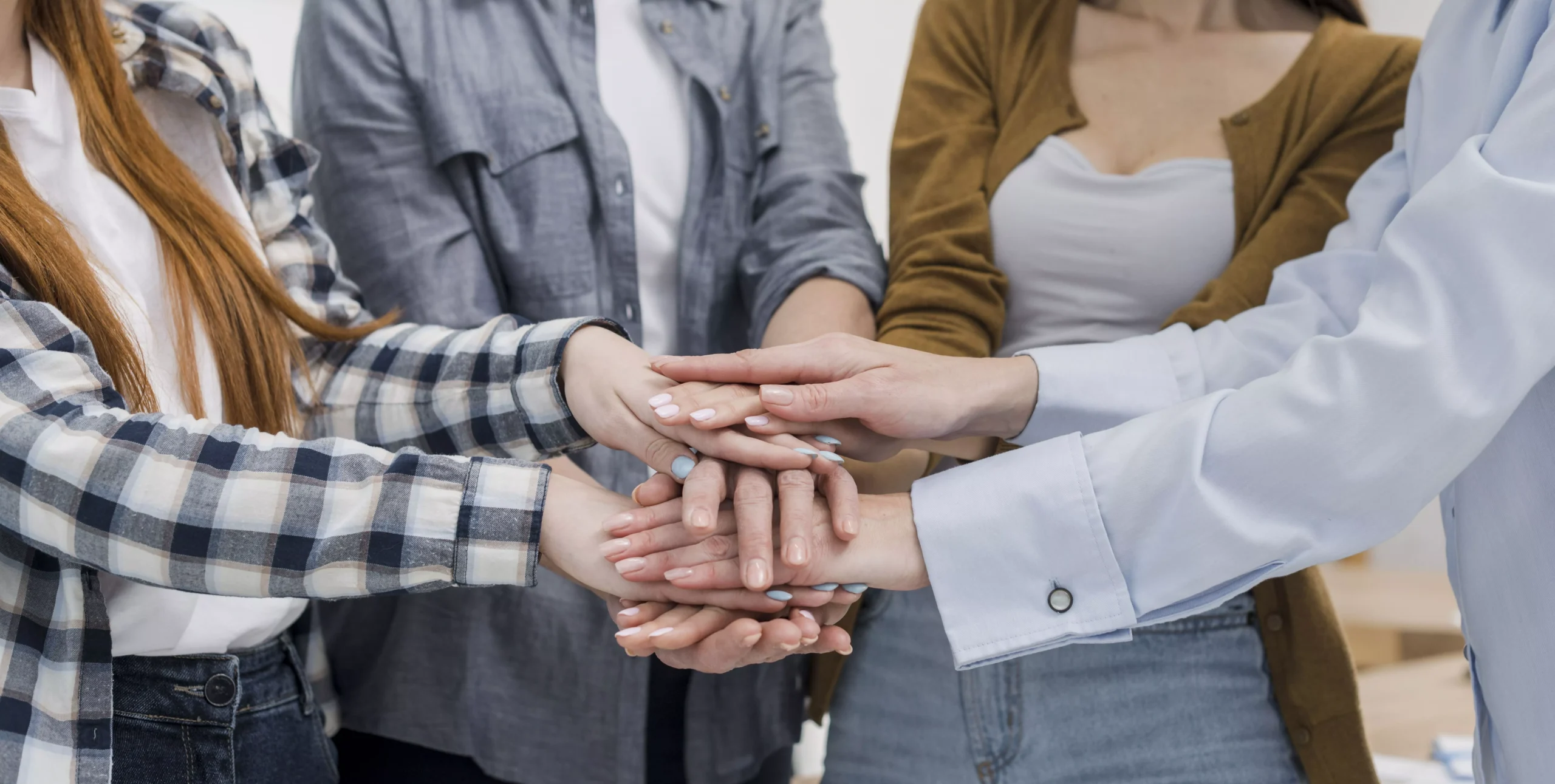 group female friends touching hands